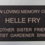 A plaque with the name of a person who died.
