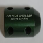 A green air ride snubber with the words " air ride snubber " on it.