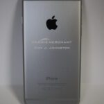 A silver iphone with the words " apple merchant city & dimension ".
