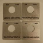Four metal plates with instructions for a vibrator pump control.