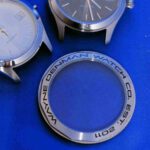 A close up of three different watches on a table