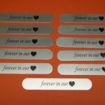 A bunch of labels that say " forever in our heart ".