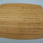 A cutting board with some writing on it