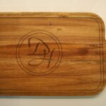 A wooden cutting board with the initials dy 4 on it.