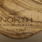 A close up of the logo on a wooden plate