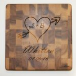 A cutting board with an arrow and heart on it.
