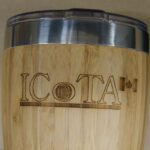 A wooden cup with the word iota engraved on it.