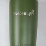A green cup with the golden life logo on it.