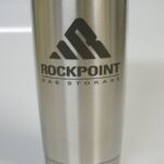 A stainless steel cup with the rockpoint logo on it.