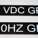 A pair of black and white stickers with the words vdc group on them.