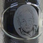 A glass with a picture of someone 's face in it.