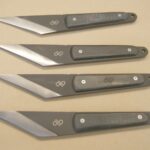 A set of four knives with different blades.