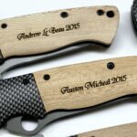 A close up of some knives with engraved names