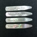 A set of four mother of pearl collar stays.