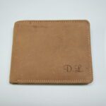 A brown wallet with initials on it