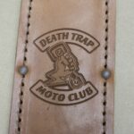 A leather wallet with the words death trap and motorcycle club on it.