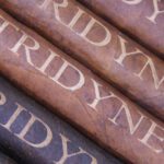 A close up of four cigars with the word friday written on them.