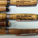 A group of pens with the names of four different golf clubs.