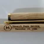 A close up of the side of a pen with a gold tip