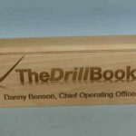 A wooden box with the name of the drill book on it.