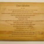 A wooden cutting board with the words " one 's wisdom."