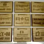 A collection of wooden plaques with logos on them.