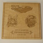 A wooden plaque with some drawings of cars