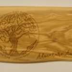 A wooden board with an image of a tree on it.
