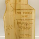 A wooden plaque with the words " our family park ".
