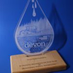 A glass award with the name devon on it.