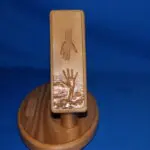 A wooden stand with a hand and palm carved into it.