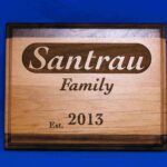 A wooden sign with the name of family and year.