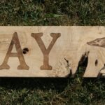 A wooden sign that says " day ".