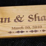 A wooden plaque with the name of a couple.