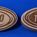Two wooden coasters with the number 1 0 and ten on them.