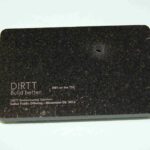 A black card with dirt written on it