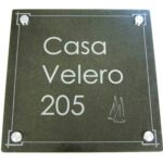 A black plaque with white lettering and numbers.