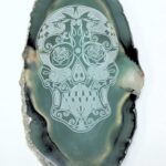 A green agate slice with a skull on it.