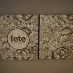 A wooden plaque with the word fete on it.